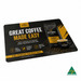 Deluxe Mouse Mat A4 (297mm x 210mm) - A mouse mat featuring a coffee theme, predominantly in black and gold, with a logo and an image of a coffee cup.