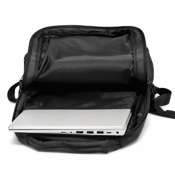Tessa Soft PU Backpack - A black soft PU backpack with an open compartment featuring a silver laptop inside.