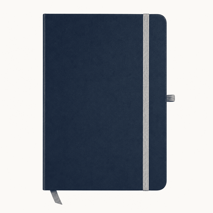Discovery A5 Notebook - A navy blue A5 notebook with a grey elastic band and a ribbon bookmark. It features a logo on the cover.