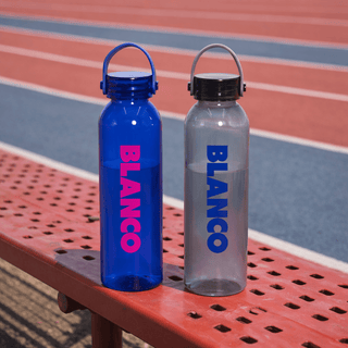 Clearview RPET 630ml Drink Bottle - A drink bottle set featuring a blue and a clear design, both with a logo and cap, resting on a bench.