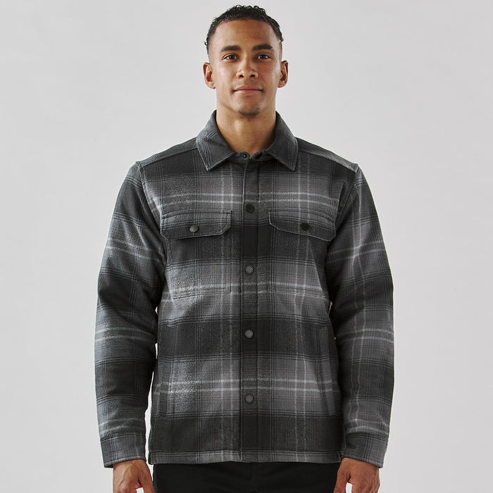 Men's Highland Sherpa Lined Plaid Jacket - A men's black and grey plaid jacket featuring a Sherpa lining and front pockets, with a branded logo.