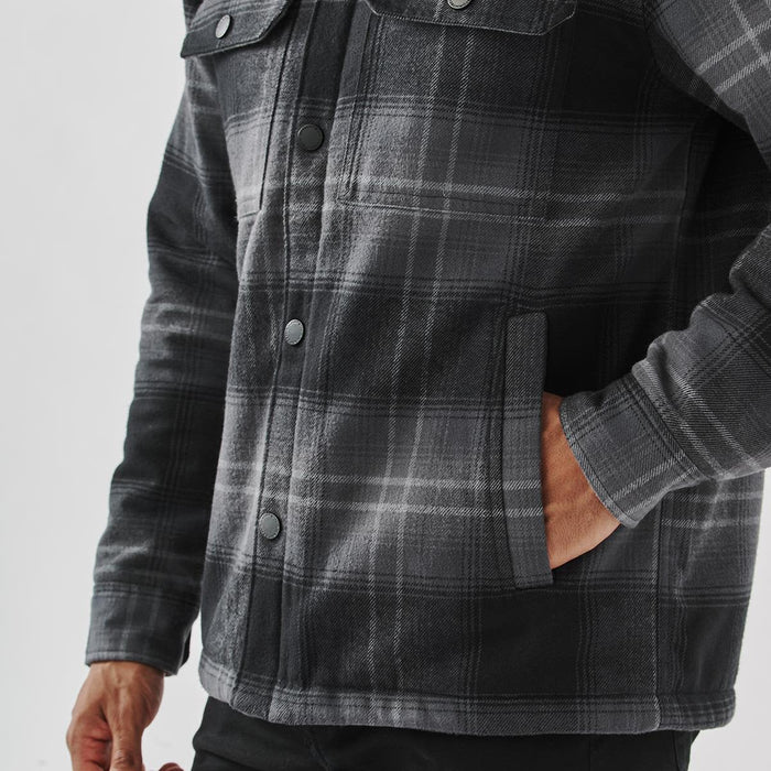 Men's Highland Sherpa Lined Plaid Jacket - A plaid jacket featuring a grey and black pattern, with a sherpa lining and front pockets. It has a logo.
