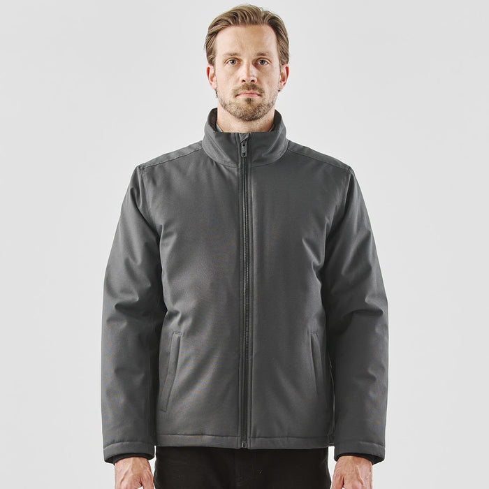 Men's Athabasca Thermal Jacket - A men's thermal jacket in grey, featuring a zip closure and a stand-up collar. The jacket has a logo on it.