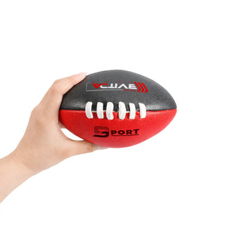 Mini Aussie Rules Ball - A hand holds a Mini Aussie Rules Ball, featuring black and red colours with white laces and a logo.