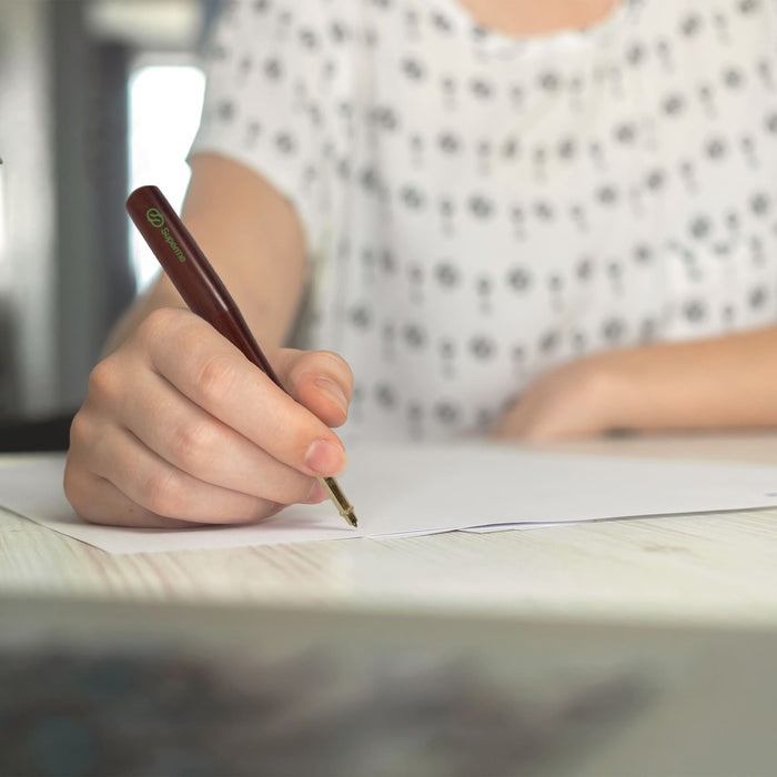 Commercial Baseball Bat Shape Pen - A brown pen with a baseball bat shape in use by a person writing on a sheet of paper.