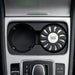 Air Freshener – New Car - An air freshener in a circular black holder, placed in a car cup holder, featuring a logo.