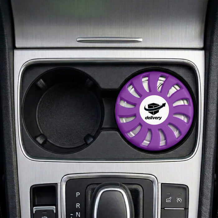 Air Freshener – Lavender - A round lavender air freshener sits in a car cup holder, featuring a logo in the centre.