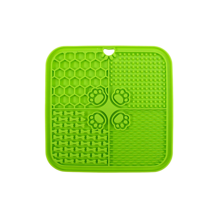 4-Section Dog Enrichment Lick Mat - A green, four-section dog enrichment lick mat featuring various textured patterns, including bones and paw prints.