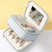 Fashion PU Leather Jewellery Case with Mirror - A light blue PU leather jewellery case with a mirror, including compartments for rings and earrings.
