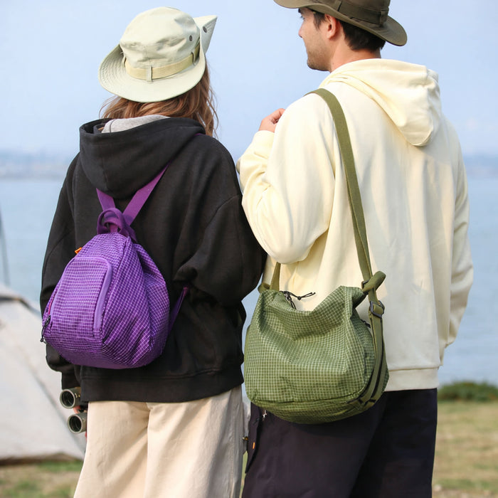 Convertible Lightweight Backpack Duffel Bag - A purple lightweight convertible backpack and a green duffel bag, held by two people wearing casual outfits and hats.