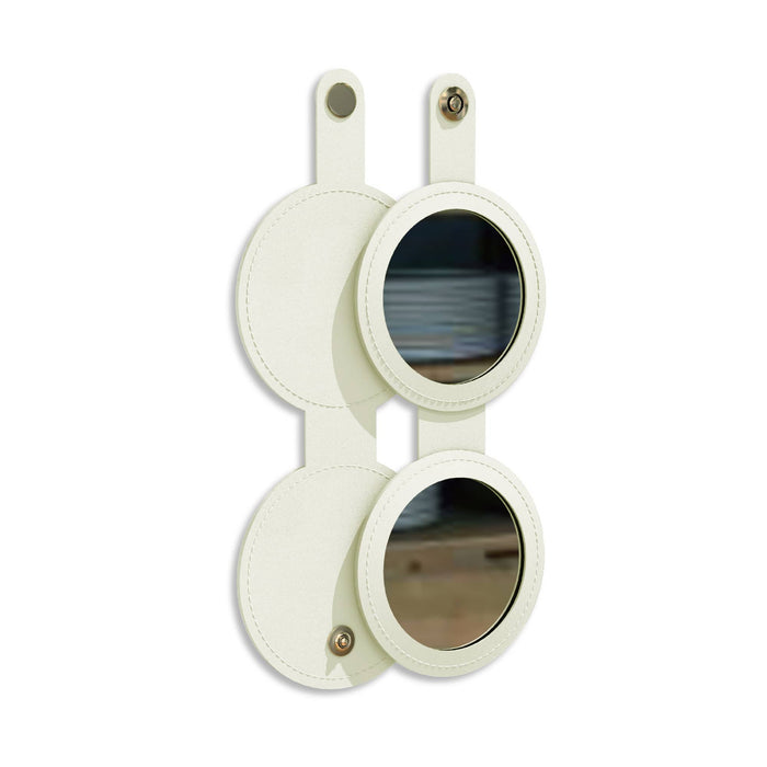 Round Folding Pocket Mirror - A round folding pocket mirror in cream, featuring two circular mirrors with a leather-like finish and a button closure.