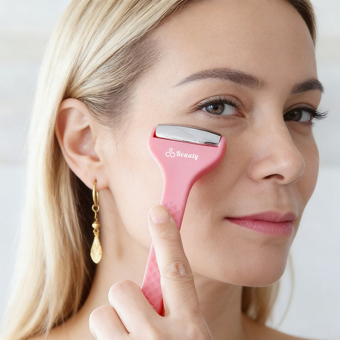 Ice Massager Roller Double Head - A pink double-headed ice massager roller held near a woman's face, featuring a logo on the handle.