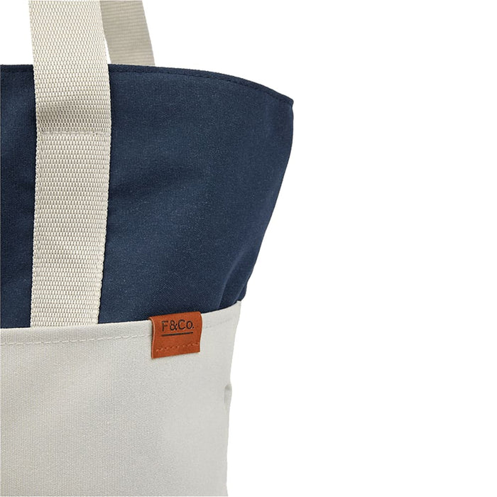 Field & Co.® Parks Day Tote - A tote bag featuring a navy blue top and a cream bottom, with a small logo tag.