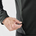 Men's Appaloosa Knit Jacket - A close-up of a men's knit jacket in dark grey, featuring a zippered pocket being opened by a hand.