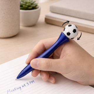 Sport’s Ball Fidget Spinner Pen - A blue pen with a spinning football on top, placed near a notebook and a small potted plant.