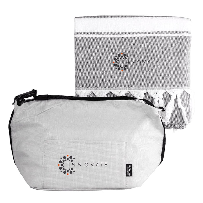 Towel & Cooler Bundle Pack - A grey cooler bag with a zipper and a matching grey towel featuring tassels. Both items have a logo.
