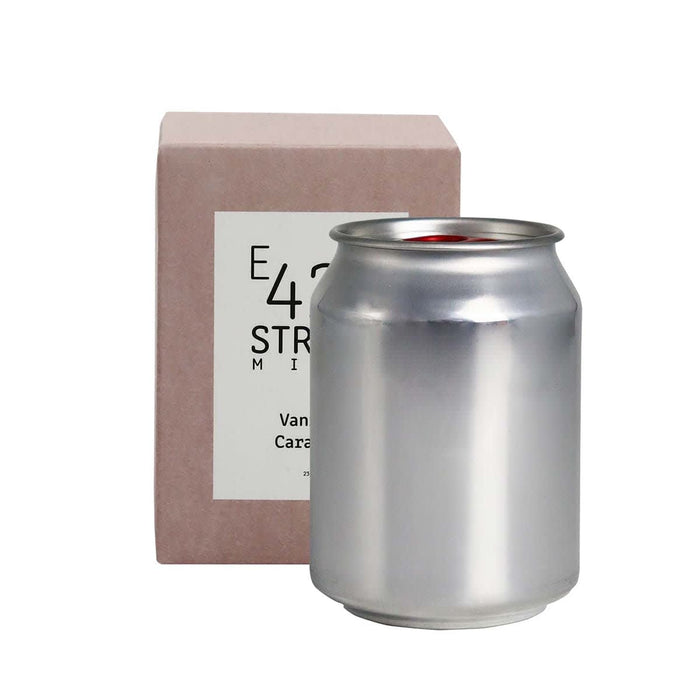 Mini East 42nd Street Can Candle - A silver can candle beside a light pink box, featuring a logo on the packaging.
