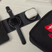 Branded Tech Kit Gift Pack - A black tech kit featuring a smartwatch, wireless earbuds case, and space for a smartphone. Includes a branded logo.