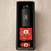 Festive Essentials Set - A black drink bottle, a red box of Christmas pudding, and a jar of sauce, all in a black hamper.