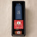 Festive Essentials Set - A blue drink bottle, a Christmas pudding, and a jar of sauce in a black box hamper.