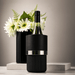 The Entertainer Set - A bottle cooler in black with a silver band, featuring a wine bottle and a vase of flowers in the background.