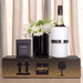 The Entertainer Set - A wine bottle in a white cooler, paired with a black box of brittle, set on a decorative box with a logo.