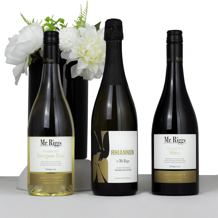The Entertainer Set - A drink bottle set featuring three wine bottles: Sauvignon Blanc, sparkling wine, and Shiraz, with a floral vase in the background.