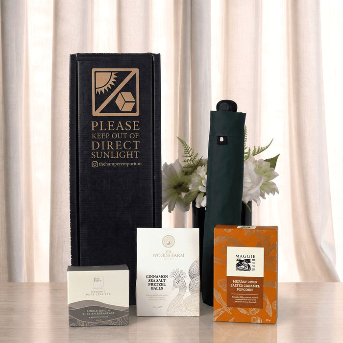 The Blunt Umbrella All Weather Set - A set featuring a dark green umbrella, a drink bottle, and various packaged items on a neutral backdrop.