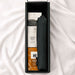 The Blunt Umbrella All Weather Set - A black umbrella and snack items in a rectangular box on a soft surface.