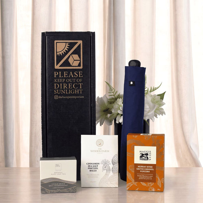 The Blunt Umbrella All Weather Set - A promotional set including a navy umbrella, two boxes, and a packet, all packaged in a black box with a logo.