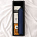 The Blunt Umbrella All Weather Set - A navy umbrella is nestled in a box with treats like cinnamon balls and other snacks. The box has a sleek design and logo.