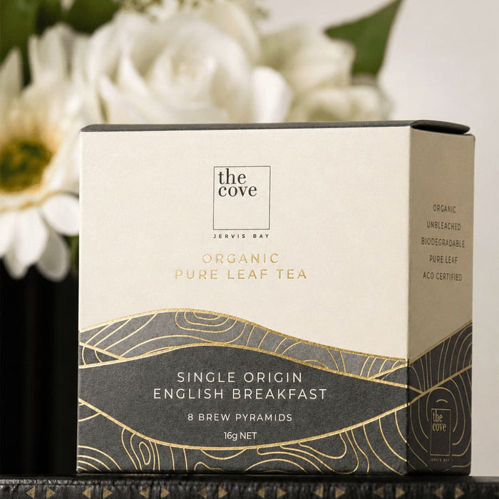 The Blunt Umbrella All Weather Set - A box of organic pure leaf tea with a white and gold design, containing eight brew pyramids. It has a logo on the front.