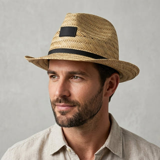 Panama Straw Hat - A Panama straw hat in natural tones with a black ribbon band, featuring a logo on the front.