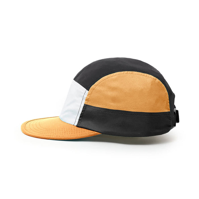 8-Panel Soft Peak Cap - A multicoloured 8-panel cap featuring black, orange, and white sections with a curved brim and a logo.