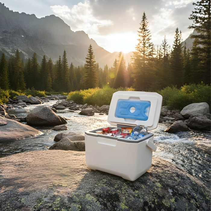 6L Cooler Box - A white 6L cooler box is open, displaying drinks and ice packs, set against a scenic natural backdrop.