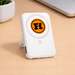 The Mellany 15W Wireless Charging Powerbank 10,000mAh - A white wireless charging powerbank with a logo, featuring a built-in stand and two USB ports.
