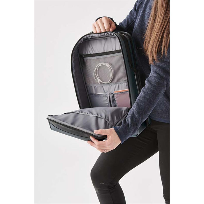 Hedmark Commuter Backpack - A person holding the open Hedmark Commuter Backpack, featuring a grey interior and multiple compartments.