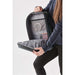 Hedmark Commuter Backpack - A person holding the open Hedmark Commuter Backpack, featuring a grey interior and multiple compartments.