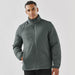 Men's Pacifica Thermal Jacket - A men's Pacifica thermal jacket in a dark green colour, featuring a zip front and a tall collar. It has a logo on the chest.