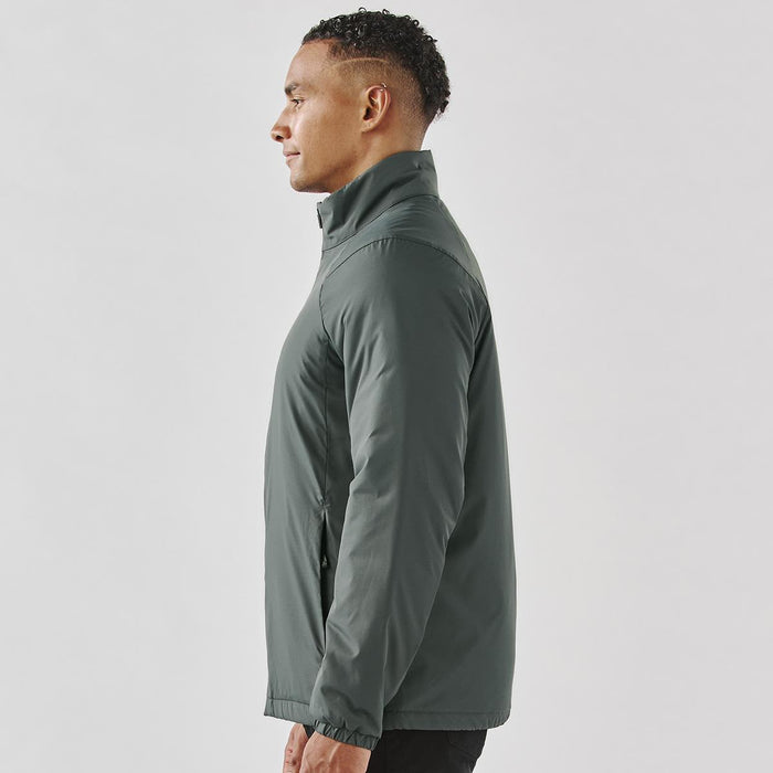 Men's Pacifica Thermal Jacket - A side view of a man wearing a men's thermal jacket in a dark green colour. The jacket features a high collar and has a logo.