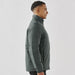 Men's Pacifica Thermal Jacket - A men's thermal jacket in dark green, featuring a high collar and a sleek, fitted design. It has a logo on it.