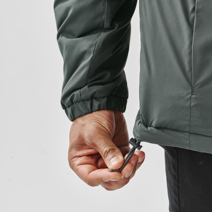 Men's Pacifica Thermal Jacket - A hand adjusts the drawstring of a dark green thermal jacket, showcasing its elastic cuffs and sleek design.