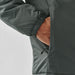 Men's Pacifica Thermal Jacket - A dark green thermal jacket with a hand in the side pocket. The jacket features elasticated cuffs and a smooth exterior.