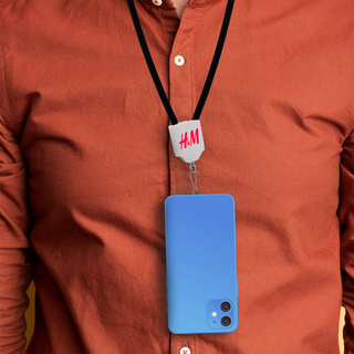 The Power Band Charging Lanyard - 60W - A blue phone is hanging from a black lanyard worn around a person's neck, featuring a logo at the top.