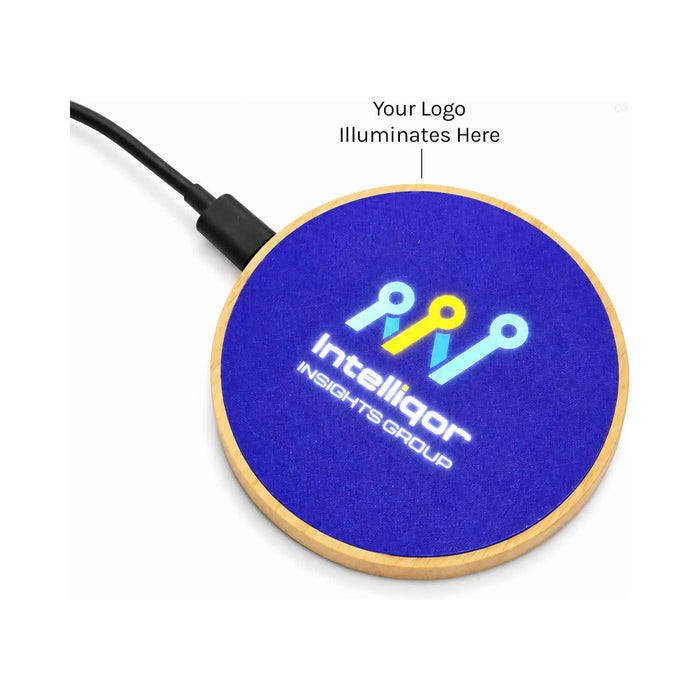 Crescent Illuminating Wireless Charger - A circular wireless charger with a wooden base and a bright blue top surface, featuring a logo in the centre.