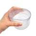 Velora Tumbler Gift Set by The Line Edit. - A clear, ribbed tumbler held in a hand, featuring a stylish design and a transparent appearance.