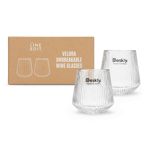 Velora Tumbler Gift Set by The Line Edit. - A set of two clear, unbreakable wine glasses with a ribbed design, packaged in a boxed set. The box features branding.