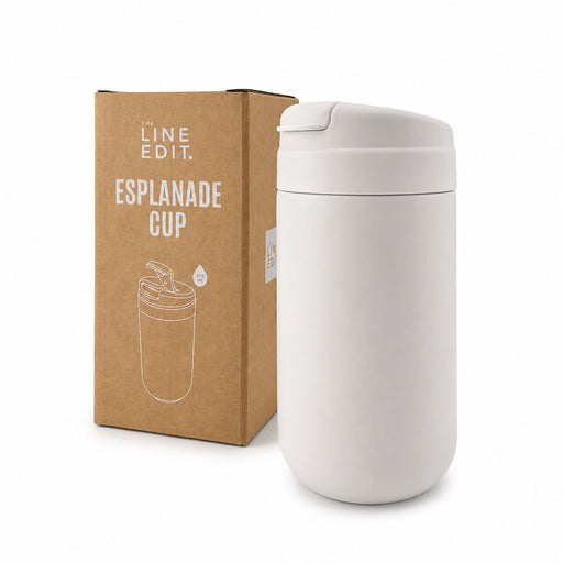 Esplanade Coffee Cup by The Line Edit. - A white coffee cup sits next to its cardboard packaging, featuring a logo and a sleek design.