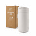 Esplanade Coffee Cup by The Line Edit. - A white coffee cup sits next to its cardboard packaging, featuring a logo and a sleek design.