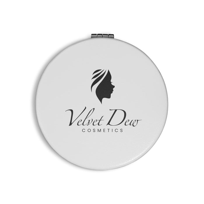 Finesse Compact Mirror - A round white compact mirror featuring a logo and an elegant design of a woman's profile.